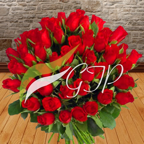 A bouquet of 60 red roses wrapped in white paper and tied with a red ribbon