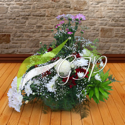 A basket of colorful flowers, including baby’s breath, pink, white, and purple chrysanthemums.