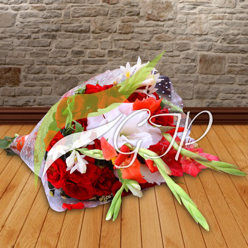 A bouquet of colorful flowers wrapped in paper and tied with a ribbon.