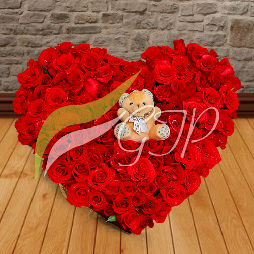 A heart-shaped box filled with 10 dozen fresh red roses